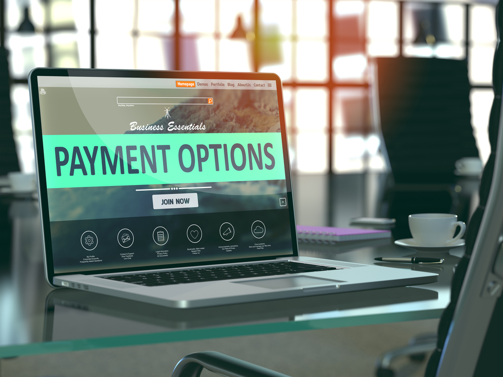Modern Workplace with Laptop showing Landing Page with Payment Options Concept. Toned Image with Selective Focus. 3D Render.-1